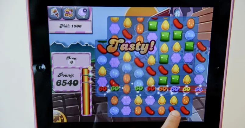 Person spelar Candy Crush på iPad.