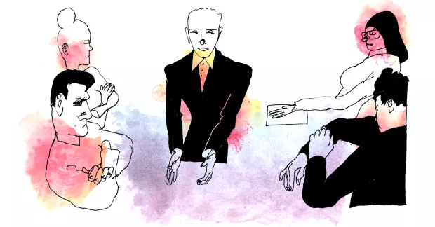 Chef står vid ett mötesbord där fyra medarbetare sitter.