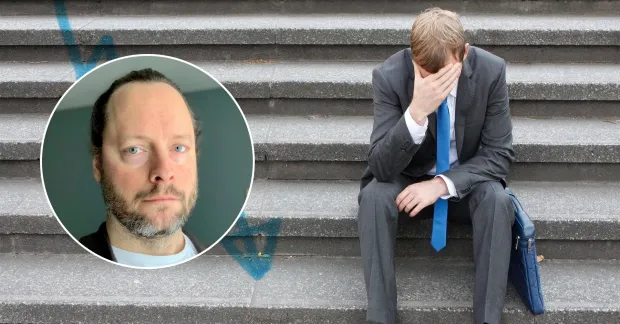 En man sitter i en trappa