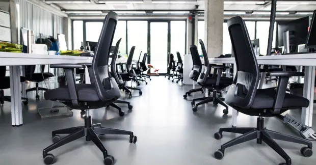Kontorsstolar i ett ljust kontor som används för att belysa fråga om det är tillåtet att ta arbetsplatsens saker hem.