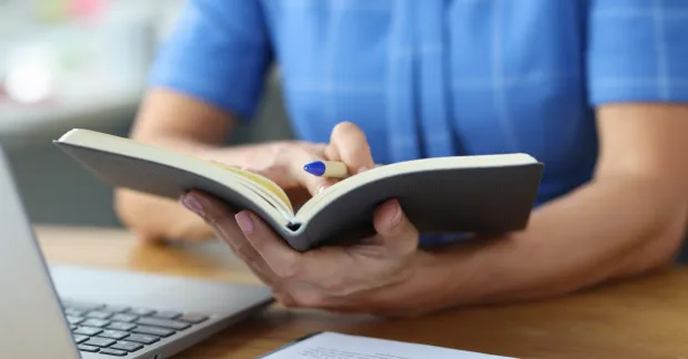 Person läser kurslitteratur på universitetet