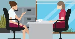 Två kvinnor samtalar med varandra vid skrivbord.